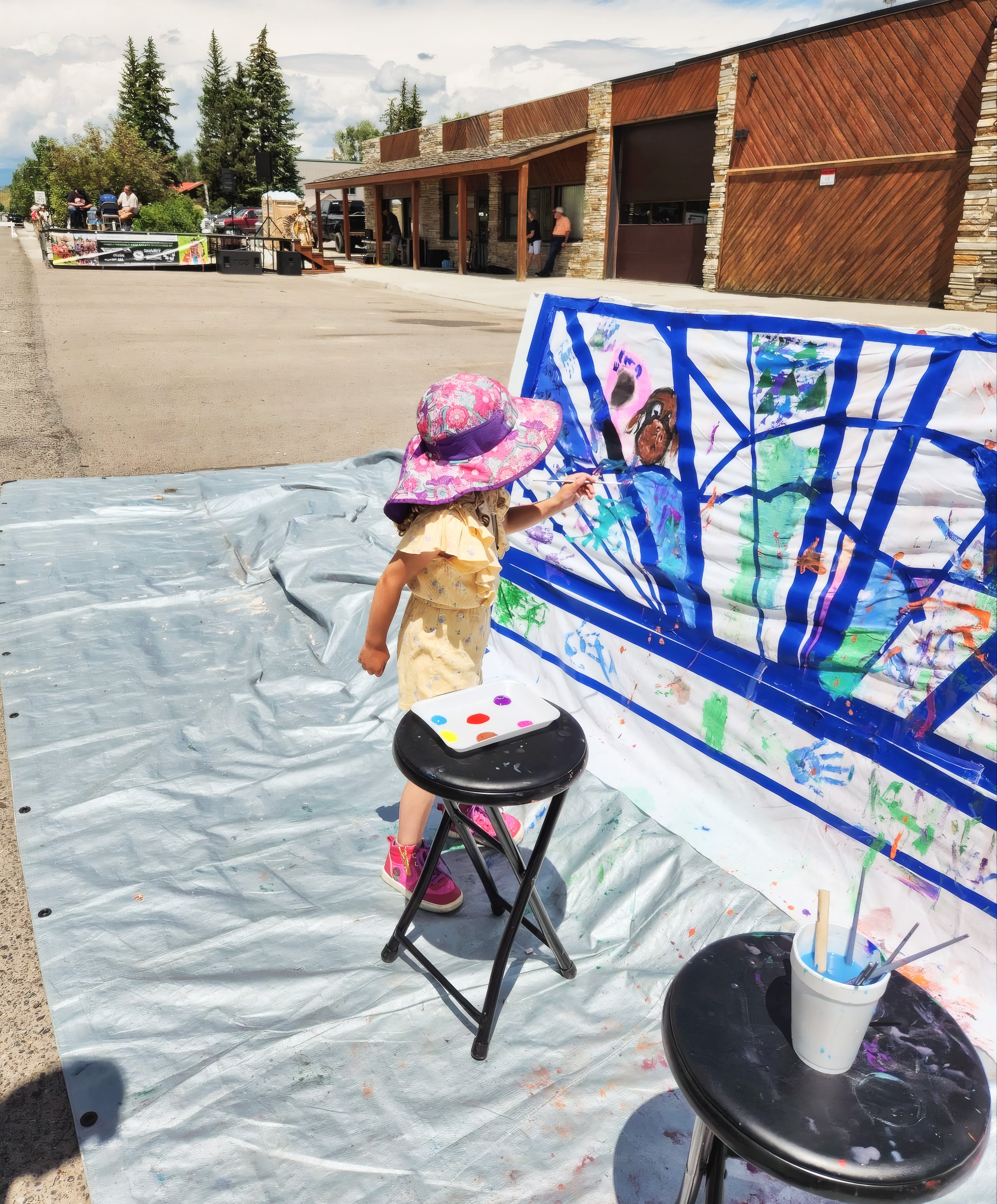 Young artist painting on canvas